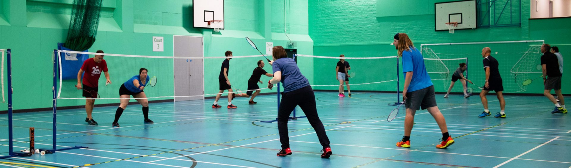 People playing mixed badminton at Keynsham Badminton Club